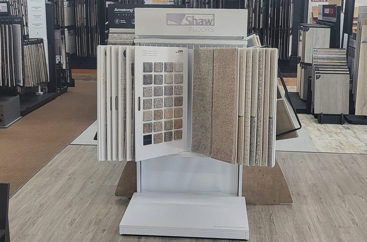Display rack of Shaw Floors carpet samples in a variety of colors and textures at the Warwick Interiors showroom in Invermere, BC.